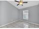 Cozy bedroom featuring a ceiling fan, window for natural light, and tile floors at 477 Bohannon Blvd, Orlando, FL 32824