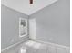 Bedroom with tile floors, neutral paint, and a window with backyard view at 477 Bohannon Blvd, Orlando, FL 32824