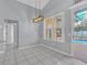 Bright dining area features tile flooring, contemporary light fixture and a large window with views of the pool at 477 Bohannon Blvd, Orlando, FL 32824