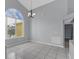 Open dining room with tile floors, a large window, and neutral gray walls at 477 Bohannon Blvd, Orlando, FL 32824