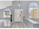 Bright foyer with gray walls, tile floors, and a decorative front door with sidelights and transoms at 477 Bohannon Blvd, Orlando, FL 32824