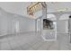 Open floor plan that leads to kitchen area features tile floor and views into other rooms in the house at 477 Bohannon Blvd, Orlando, FL 32824