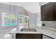 Granite countertops and stainless steel appliances are featured in this kitchen with tile flooring overlooking the pool at 477 Bohannon Blvd, Orlando, FL 32824