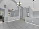 Spacious living room with tile floors, gray walls, and an open layout flowing into the kitchen and other living areas at 477 Bohannon Blvd, Orlando, FL 32824