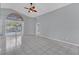Bright living room boasts tile floors, ceiling fan, and sliding glass doors leading to a screened-in pool at 477 Bohannon Blvd, Orlando, FL 32824