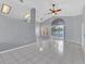 A spacious, naturally lit living room with tile floors, a modern ceiling fan, and direct views of the pool at 477 Bohannon Blvd, Orlando, FL 32824