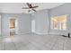 Bright living room features tile flooring, ceiling fan, and ample natural light at 477 Bohannon Blvd, Orlando, FL 32824