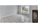 Bright room with tile flooring, a large window, and neutral gray walls at 477 Bohannon Blvd, Orlando, FL 32824