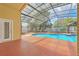 Enclosed pool area features a swimming pool, screen enclosure, and direct access to the home at 477 Bohannon Blvd, Orlando, FL 32824