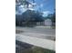 Home's front yard is surrounded by a white metal fence and has an attached garage at 48 E Par St, Orlando, FL 32804