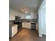 Modern kitchen featuring stainless steel appliances, granite countertops, and white cabinetry at 48 E Par St, Orlando, FL 32804