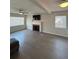 Spacious living room featuring a cozy fireplace, ceiling fan, and new hardwood flooring at 48 E Par St, Orlando, FL 32804
