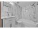 Bathroom features a tub, shower, toilet, vanity, mirror and tiled walls at 4804 Beacon St, Orlando, FL 32808