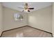 Bedroom features light wood floors, ceiling fan, a window and neutral colored walls at 4804 Beacon St, Orlando, FL 32808