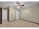 Bedroom with light wood floors, ceiling fan, trim, and a closet with white doors at 4804 Beacon St, Orlando, FL 32808