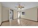 Bright bedroom features a ceiling fan, light wood floors, and ample natural light from a window at 4804 Beacon St, Orlando, FL 32808