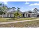 Well-maintained single-story home featuring a tidy front lawn, mature landscaping, and a convenient driveway at 4804 Beacon St, Orlando, FL 32808