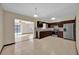 Well-equipped kitchen with dark wood cabinets, stainless steel appliances, and a view of the adjacent living area and pool at 4804 Beacon St, Orlando, FL 32808