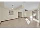 Bright living room with tile floors, a ceiling fan, and a large window providing plenty of natural light at 4804 Beacon St, Orlando, FL 32808