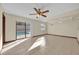 Bright living room with tile floors, a ceiling fan, and sliding glass doors leading to the outdoor pool area at 4804 Beacon St, Orlando, FL 32808