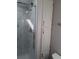 Modern bathroom with a glass-enclosed shower featuring marble-style tile and built-in storage at 50989 Highway 27 # 105, Davenport, FL 33897