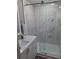 Modern bathroom with a glass-enclosed shower featuring marble-style tile at 50989 Highway 27 # 105, Davenport, FL 33897
