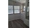 This cozy bedroom features three windows, wood flooring and built in closet at 50989 Highway 27 # 105, Davenport, FL 33897