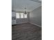 Spacious dining room with wood-look flooring, brightened by natural light from multiple windows at 50989 Highway 27 # 105, Davenport, FL 33897