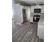 Modern kitchen with stainless steel appliances, including a refrigerator and oven, set on wood-look flooring at 50989 Highway 27 # 105, Davenport, FL 33897