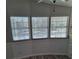 A sun filled living room features three windows, paneled walls and modern flooring at 50989 Highway 27 # 105, Davenport, FL 33897