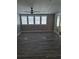 Spacious living room features wood-look flooring and natural light, offering a welcoming and open space at 50989 Highway 27 # 105, Davenport, FL 33897