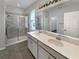 Contemporary bathroom features dual sinks, tiled shower, and a large mirror at 5323 Rochester Pl, St Cloud, FL 34771