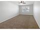 Cozy bedroom featuring neutral carpet, a ceiling fan, and bright natural light at 5323 Rochester Pl, St Cloud, FL 34771