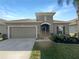 Beautiful home featuring well-maintained landscaping, two car garage and a neutral color palette at 5323 Rochester Pl, St Cloud, FL 34771