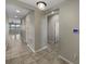 Inviting hallway with ceramic tile floors and modern lighting at 5323 Rochester Pl, St Cloud, FL 34771