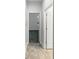 Hallway with tile flooring leading to a bedroom with a window at 5323 Rochester Pl, St Cloud, FL 34771