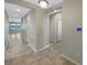 Bright hallway with tile flooring, access to multiple rooms, and smart home technology at 5323 Rochester Pl, St Cloud, FL 34771