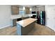 Updated kitchen features stainless steel appliances, stone counters, and island seating at 5323 Rochester Pl, St Cloud, FL 34771