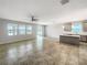 Spacious living room with natural light, ceiling fan, and open concept layout at 5323 Rochester Pl, St Cloud, FL 34771