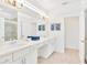 Bright bathroom with double sinks, granite countertops, and a glass-enclosed shower at 537 Marcello Blvd, Kissimmee, FL 34746
