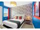 Modern bedroom features creative wallpaper and fun decorations at 537 Marcello Blvd, Kissimmee, FL 34746