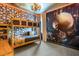 Themed bedroom with custom bunk beds, unique decor, and Indiana Jones mural at 537 Marcello Blvd, Kissimmee, FL 34746