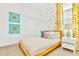 Bright bedroom with a bed, colorful pillows, modern curtains and decorative artwork for a vibrant, cozy space at 537 Marcello Blvd, Kissimmee, FL 34746