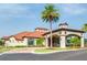 Exterior view of a clubhouse with tile roof, clock tower, and tropical landscaping at 537 Marcello Blvd, Kissimmee, FL 34746