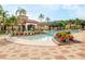 Exterior view of a zero entry community pool with seating and colorful landscaping at 537 Marcello Blvd, Kissimmee, FL 34746