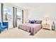 Bright main bedroom with decorative headboard, a cozy chair, and bright windows at 537 Marcello Blvd, Kissimmee, FL 34746