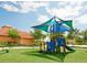 Playground with slide and sunshade on artificial turf next to a sand volleyball court at 537 Marcello Blvd, Kissimmee, FL 34746