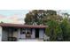 Inviting single-story home displaying a front porch area, enhanced with a beautiful shade tree at 5711 Riordan Way, Orlando, FL 32808