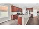 A kitchen featuring stainless steel appliances, granite countertops, dark wood cabinets and wood flooring at 6017 Snapdragon Rd, Minneola, FL 34715