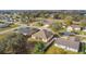 A sunny aerial view showing the house with a screened patio and other homes in this quiet residential neighborhood at 603 Deauville Ct, Kissimmee, FL 34758